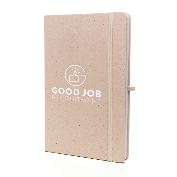 A5 notebook features a stylish fruit paper cover, recycled inner pages, recycled elastic closure, recycled ribbon and pen loop. It's compact and functional, with a variety of colours available to complement your branding.